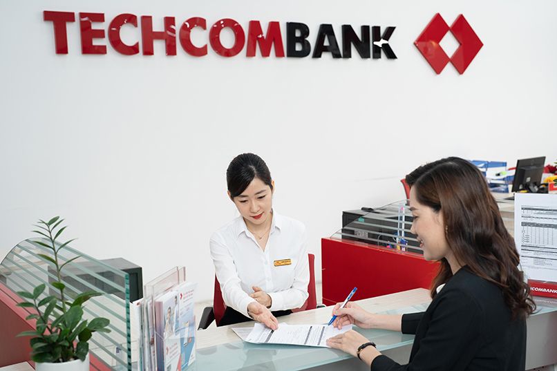 Giao dịch viên Techcombank hướng dẫn khách hàng làm thủ tục phát hành lại thẻ tín dụng